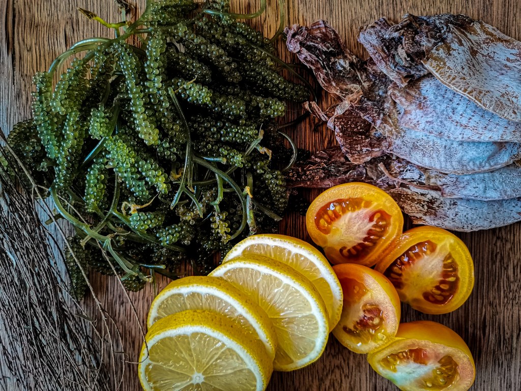 Filipino dried squid served with lato sea grapes and tomato