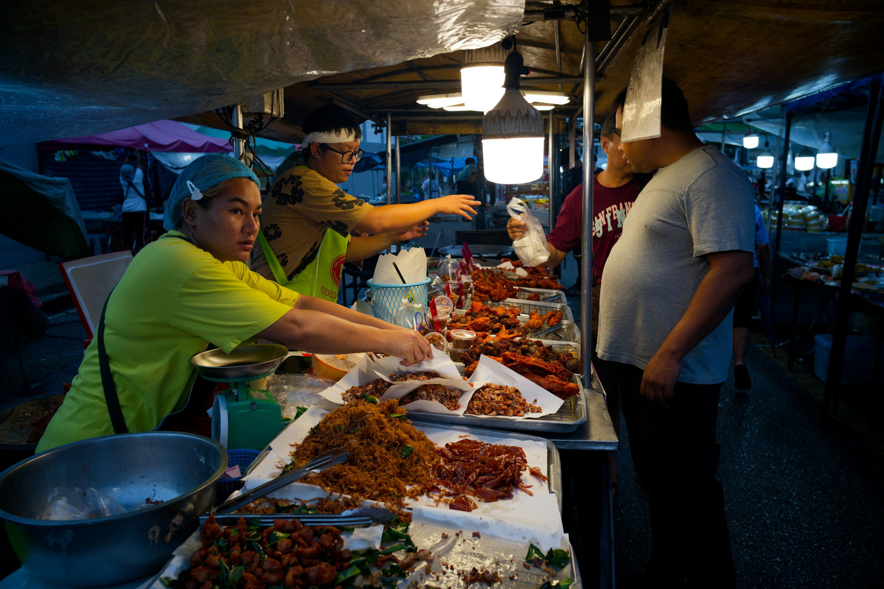 Vendor preparing Filipino street food at a night market