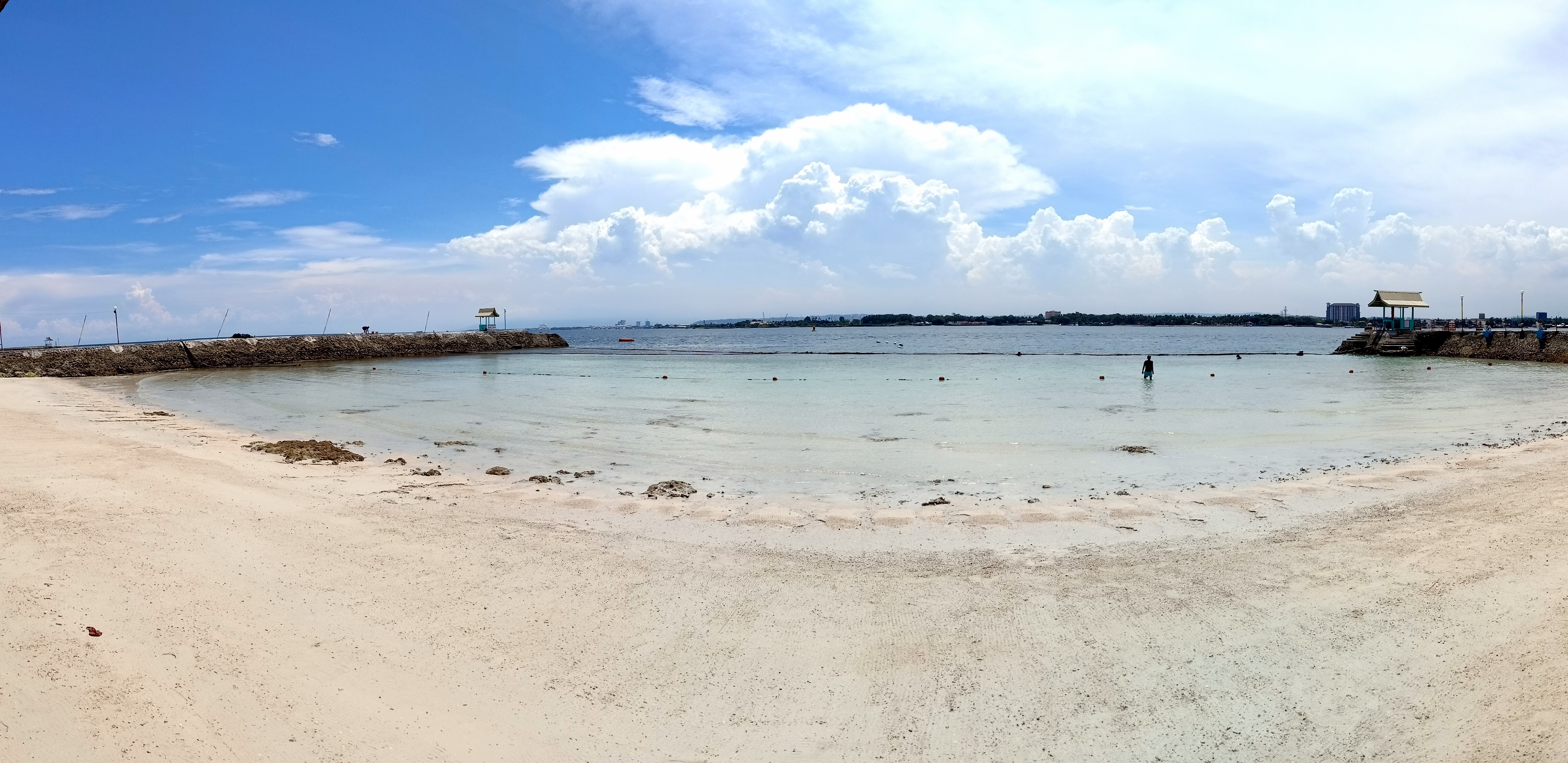 White sand beach and calm blue water at Paradise Island Park and Beach Resort on Samal Island